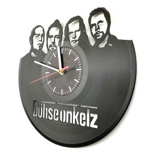 Angled view of Böhse Onkelz vinyl record clock highlighting grooves, band silhouette cutout, and precision clock hands.