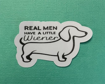 May include: White sticker with a black dachshund silhouette and the text "REAL MEN HAVE A LITTLE WIENER".