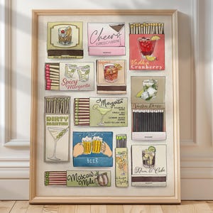 May include: A framed print featuring vintage-style illustrations of cocktail matchboxes. The artwork showcases various drinks like Old Fashioned, Espresso Martini, Vodka Cranberry, Spicy Margarita, and Dirty Martini, with the names of the cocktails displayed.