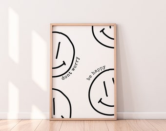 Könnte beinhalten: Ein gerahmter Druck mit weißem Hintergrund und schwarzen Smiley-Gesichtern. Der Text "don't worry be happy" ist in Schwarz auf dem Druck geschrieben.