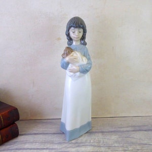 Nao / Lladro Figurine, Girl holding a Puppy / Dog Number 525, dated 1990