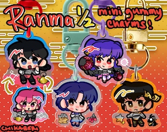 May include: Five colorful anime character charms with keychains. The charms are made of clear plastic with a cartoon image of a character from the anime series Ranma 1/2. The charms feature the characters Ranma, Akane, Shampoo, Ryoga, and Ukyo. The charms are labeled "mini gummy charms!"