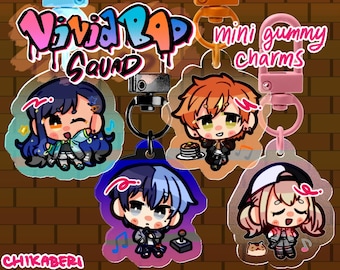 May include: Four colorful acrylic charms featuring anime-style characters with the text "Vivid Rap Squad" and "mini gummy charms".