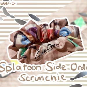 May include: A brown scrunchie with a colorful print of various Splatoon characters and the text "Side Order" written in white.