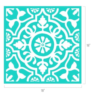 May include: A square stencil featuring a white symmetrical floral and geometric pattern on a bright turquoise background. The design includes a central flower surrounded by scrolling leaves and ornate borders. The stencil measures 18 inches by 18 inches.