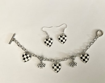 May include: A silver chain bracelet with a checkered heart charm and two checkered heart dangle earrings. The bracelet has two additional charms that resemble checkered flags.