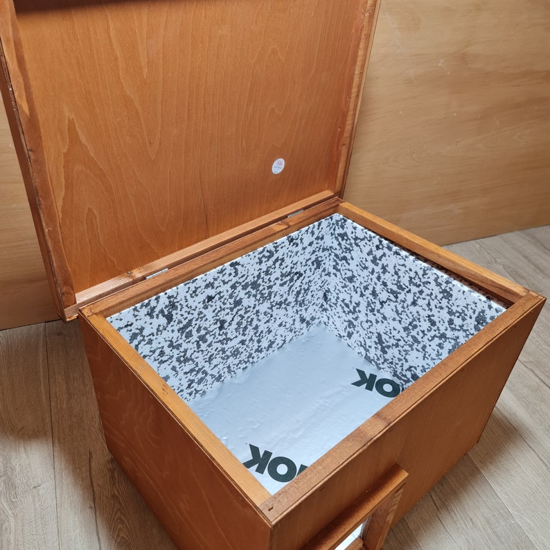 May include: A wooden box with a hinged lid, open to reveal a white interior with a speckled pattern. The interior is lined with a white material with the word "OK" printed on it.