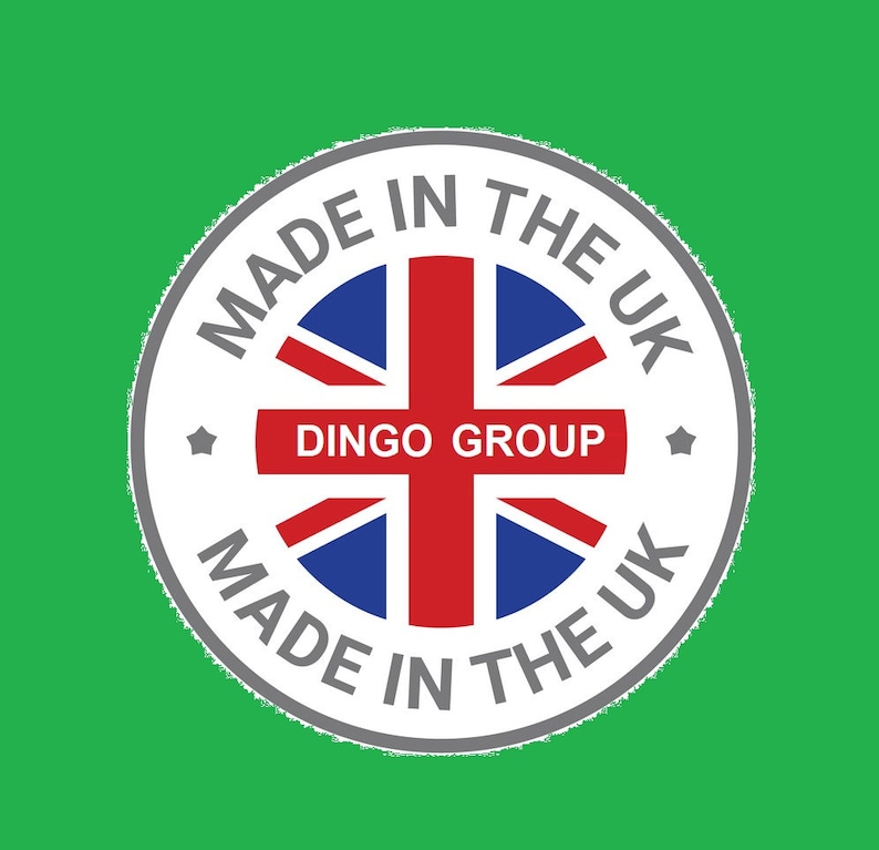 May include: A white circle with a gray border and the text "MADE IN THE UK" around the edge. Inside the circle is a red, white, and blue Union Jack flag with the text "DINGO GROUP" in a red banner across the middle.