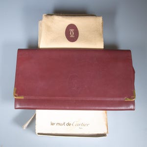 Vintage Les Must De CARTIER large leather travel wallet - unisex - comes in original box (worn) and cleaning cloth - burgundy / bordeaux