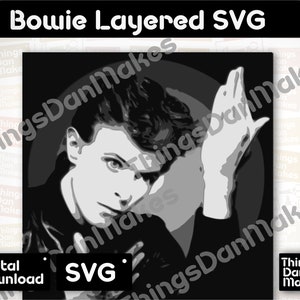 May include: Black and white layered SVG design of David Bowie with his signature lightning bolt makeup and a hand raised to his face.