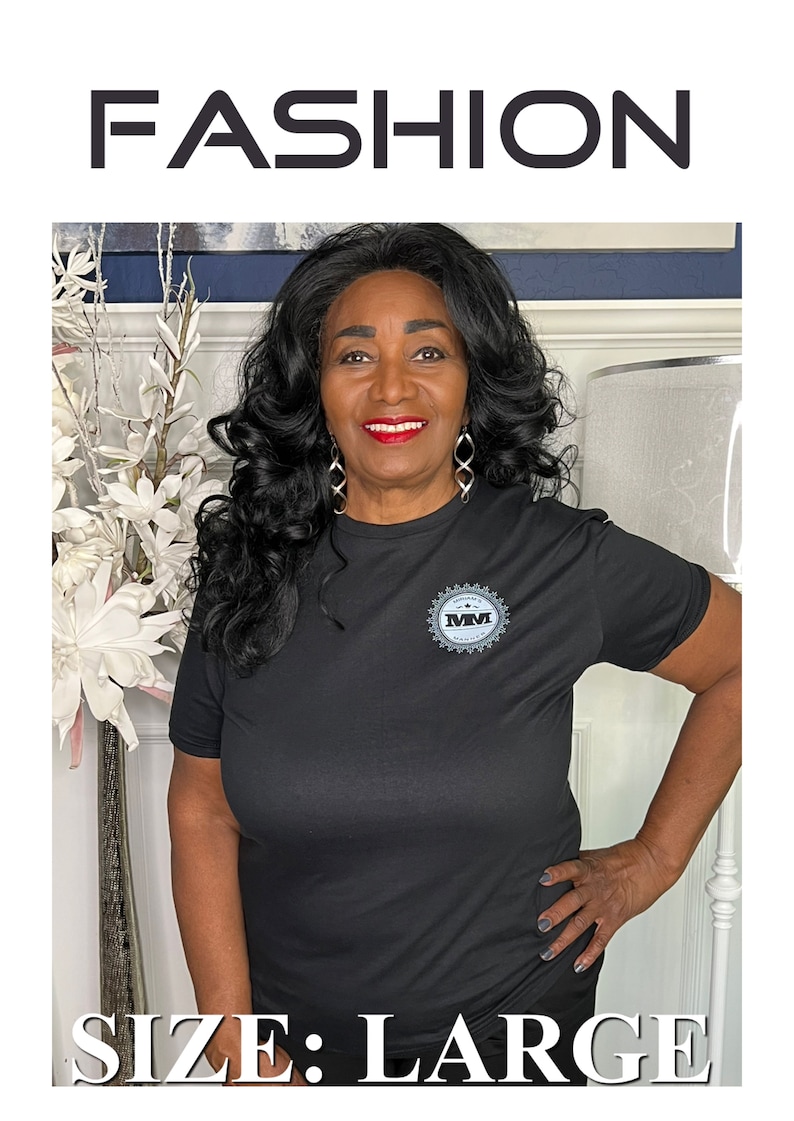 K&ouml;nnte beinhalten: Schwarzes T-Shirt mit kurzen &Auml;rmeln und einem grauen Logo mit der Aufschrift "MM" in einem Kreis. Das T-Shirt wird von einer Person mit dunklen Haaren und einem L&auml;cheln getragen. Der Text "SIZE: LARGE" befindet sich am unteren Rand des Bildes.