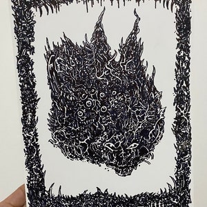 May include: Black and white illustration of a creature with multiple eyes and a detailed, textured design. The artwork is framed with a border of spiky, organic shapes, creating a striking contrast against the white background.