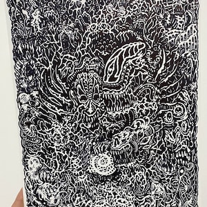 May include: Black and white abstract illustration with intricate details and swirling patterns. The artwork features a central figure with a large, open mouth and multiple eyes.