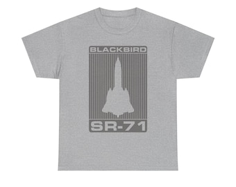 May include: A heather gray t-shirt featuring a graphic of the SR-71 Blackbird aircraft. The design includes the text "BLACKBIRD" above the aircraft silhouette and "SR-71" below. The shirt is a classic crew neck style.