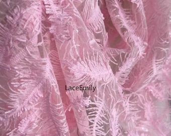 Puede incluir: Primer plano de una delicada tela rosa con una textura de plumas. La tela parece ser un encaje transparente, con detalles intrincados y una estética suave y romántica. El texto "LaceEmily" es visible.