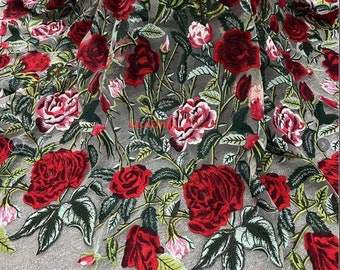 May include: Red embroidered roses on a sheer white fabric. The roses are in various stages of bloom and are surrounded by green leaves.