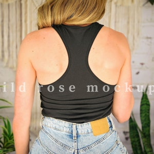 May include: A black racerback tank top with a scoop neck. The tank top is made of a soft, stretchy fabric and is perfect for layering or wearing on its own.
