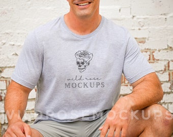 May include: A gray t-shirt with a black and white skull with a rose on top. The text "wild rose MOCKUPS" is printed below the skull.