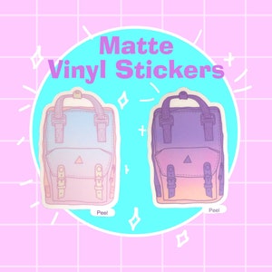 May include: Two matte vinyl stickers of pastel colored backpacks with a gradient design. The stickers are on a light blue background with white stars and the text "Matte Vinyl Stickers".