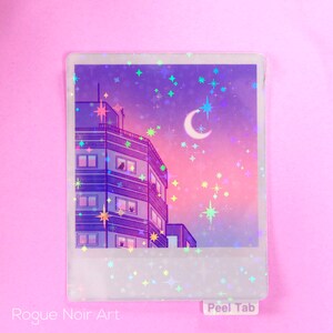 May include: A holographic sticker featuring a purple and pink cityscape with a crescent moon and stars. The sticker has a white border and the text "Peel Tab" at the bottom.