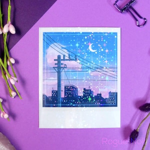 May include: A blue and purple glittery sticker with a cityscape silhouette, a crescent moon, and stars against a blue sky with clouds. The sticker is in a white frame with a grid pattern.