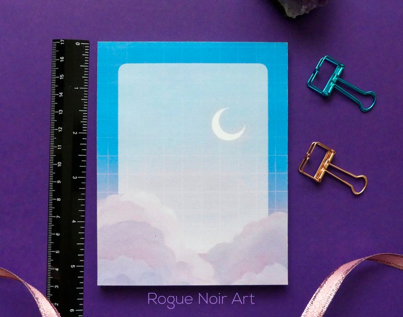 May include: A blue and white printable card with a crescent moon and clouds. The card has a grid pattern and the text "Rogue Noir Art" at the bottom.