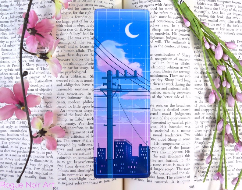 May include: A blue and pink aesthetic bookmark with a cityscape silhouette, a crescent moon, and a power line with birds. The bookmark has a grid pattern overlay.
