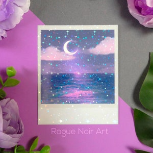 May include: A holographic print of a crescent moon over a sparkling ocean with a pink and purple sky. The print has a white border and the text "Rogue Noir Art" at the bottom.