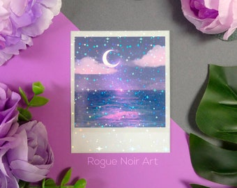 May include: A holographic print of a crescent moon over a sparkling ocean with a pink and purple sky. The print has a white border and the text "Rogue Noir Art" at the bottom.