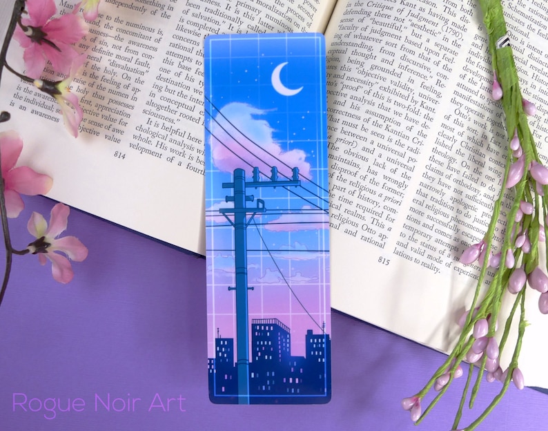 May include: A city skyline at night with a crescent moon in the sky. The sky is a gradient of pink, purple, and blue. There are power lines and a tall pole with a transformer. The city buildings are silhouetted against the sky.