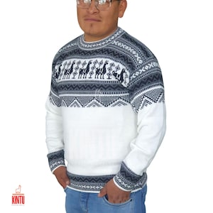 May include: White and navy blue sweater with a crew neck and long sleeves. The sweater features a geometric pattern and a design of llamas. The cuffs and neckline have a patterned border. The sweater is made of a soft material.