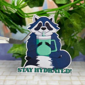 Sticker raton laveur en vinyle pour rester hydraté