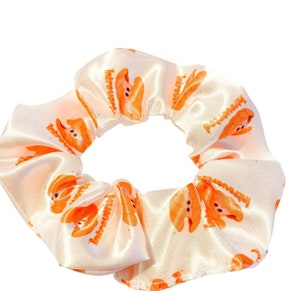 Introverted clam orange hair Scrunchie