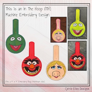 May include: Machine embroidery designs featuring cartoon character faces in green, red, yellow, and tan. The designs are in the shape of a key, with a loop at the top. The text on the image says, "This is an In The Hoop (ITH) Machine Embroidery Design."