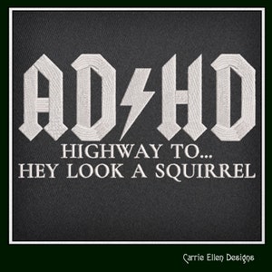 May include: White embroidered text on a black background that reads "ADHD Highway to... Hey Look A Squirrel".