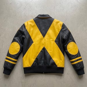 May include: A black and yellow leather jacket featuring a large yellow X pattern across the back, yellow circular elbow patches, and two horizontal yellow stripes on each sleeve. The jacket has a black collar, black ribbed cuffs, and a black hem.