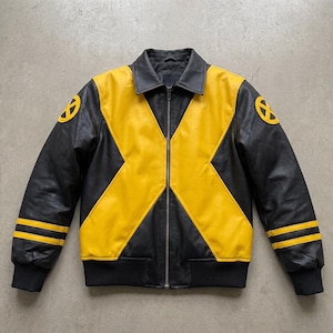 May include: A black and yellow leather jacket featuring a prominent X-shaped design across the front. The sleeves include two horizontal yellow stripes and a circular yellow X-Men logo patch on each shoulder. It has a full-length front zipper.