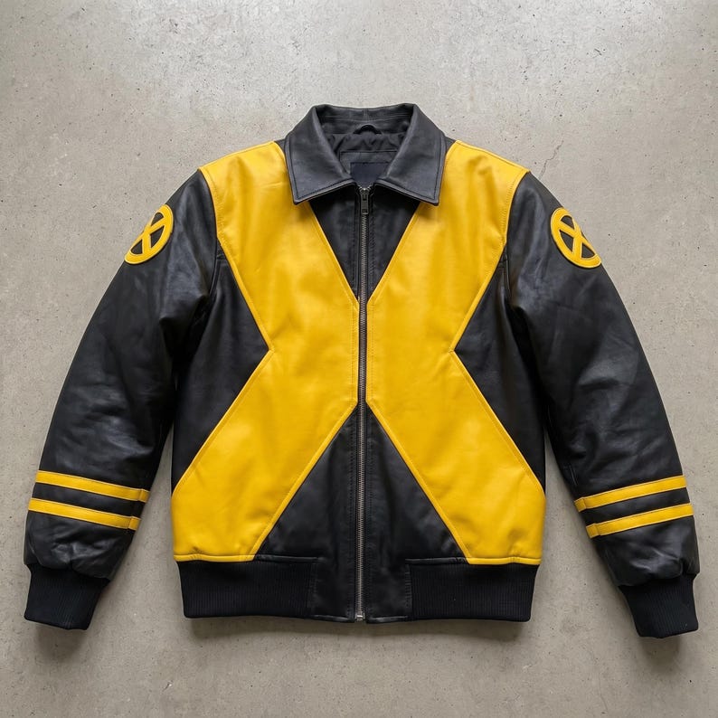 May include: A black and yellow leather jacket featuring a prominent X-shaped design across the front. The sleeves include two horizontal yellow stripes and a circular yellow X-Men logo patch on each shoulder. It has a full-length front zipper.