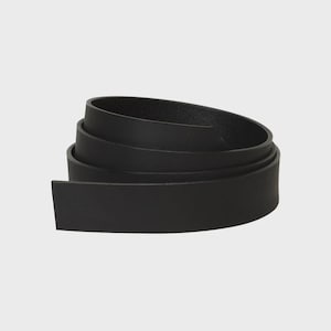 May include: A solid black belt coiled into a circular shape. The belt features a smooth, matte finish with a consistent width throughout its length. The material appears flexible, allowing it to be rolled into multiple overlapping layers.