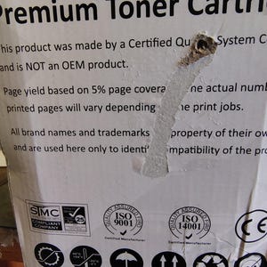 May include: White cardboard box with text that reads "Premium Toner Cartridge." The box includes various certification logos, including ISO 9001 and ISO 14001. The text also mentions that the product is not an OEM product.