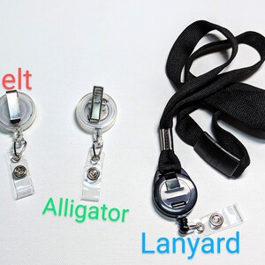 May include: A collection of badge holders and a lanyard. Two badge holders with a belt clip and a clear plastic strap are shown. A black lanyard with a retractable badge holder and a black plastic clasp is also included. The word "Belt", "Alligator", and "Lanyard" are written on the image.