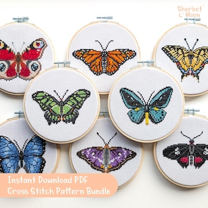 May include: A set of 8 cross stitch patterns featuring different butterfly designs. The patterns are printed on white embroidery hoops with a light wood frame. The butterflies are in various colours, including red, blue, green, orange, yellow, and black.