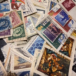 May include: A collection of assorted postage stamps featuring diverse imagery including Olympic athletes, historical figures, botanical illustrations, and artistic reproductions. The stamps vary in color, shape, and origin, displaying various postmarks.