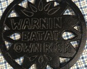 Vintage Cast Iron Round Trivet Joke Saying quot Warnin 39 Eat at Own Risk quot Sunflower Design 5.5 quot