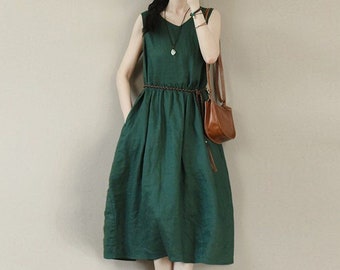 May include: A dark green sleeveless linen dress with a drawstring waist and pockets. The dress is midi length and has a relaxed fit.