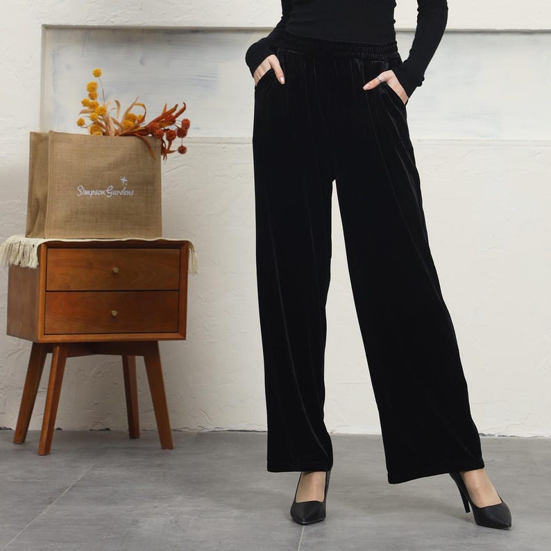 May include: Black velvet wide-leg pants with a high waist and a relaxed fit.