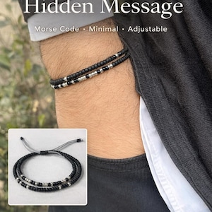 May include: Black beaded bracelet set with silver accents, worn on a wrist. The bracelets are described as Morse Code, Minimal, and Adjustable. The image also includes a smaller inset image of the bracelet set.