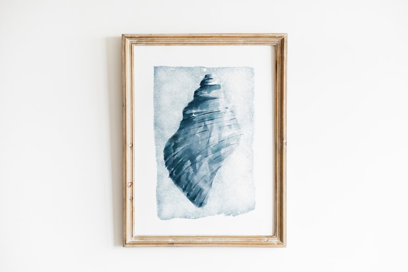 May include: A framed watercolor painting of a blue seashell on a white background.