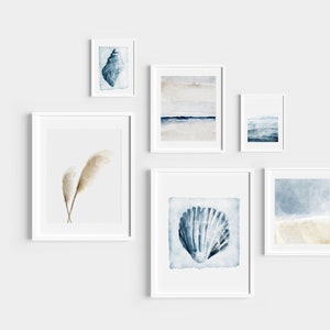 May include: A set of six framed watercolor prints featuring seashells, feathers, and abstract ocean scenes in shades of blue, white, and beige.