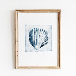 May include: A framed watercolor painting of a blue seashell on a white background. The seashell is the focal point of the painting and is depicted in a realistic style.